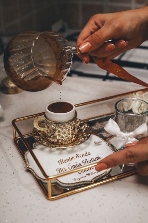 Free Elegant Turkish coffee being poured into a decorative cup on a luxurious tray. Stock Photo