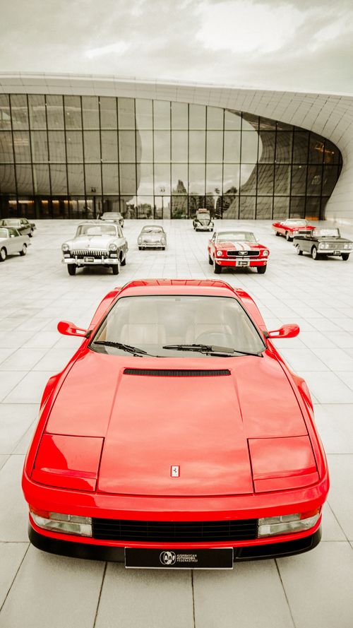 Free Classic Ferrari amidst vintage cars at Baku's Heydar Aliyev Center. Stock Photo