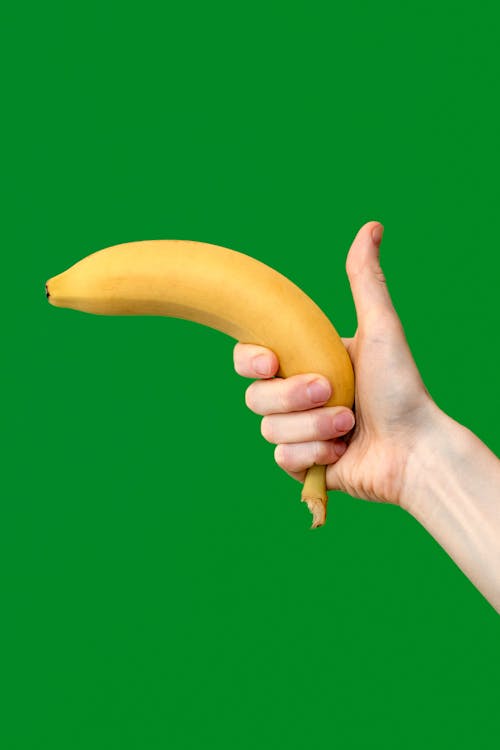 Person Holding a Banana with a Thumb up 