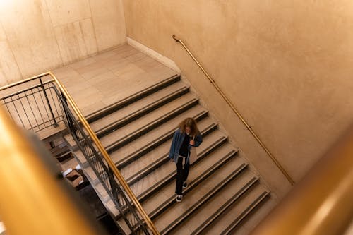 High Angle Shot of a Person Walking Down the Stairs