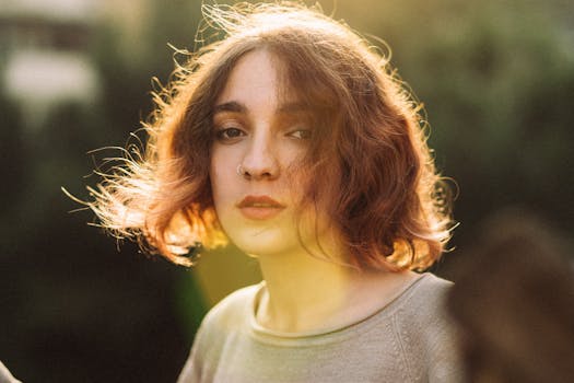 Captivating portrait of a woman with warm sunbeams illuminating her face in Baku, Azerbaijan.