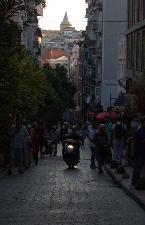 People and Motor Scooter on Street in Galata in Istanbul