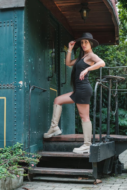 Woman Posing in Black Dress and Hat