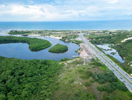 Breathtaking aerial view of coastal landscapes, lush greenery, and ocean near Fortaleza, Brazil.