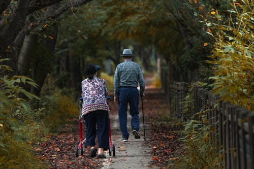 Elderly Woman and Man Walking in Park