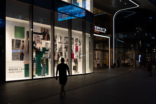 Man Walking near Clothes Store
