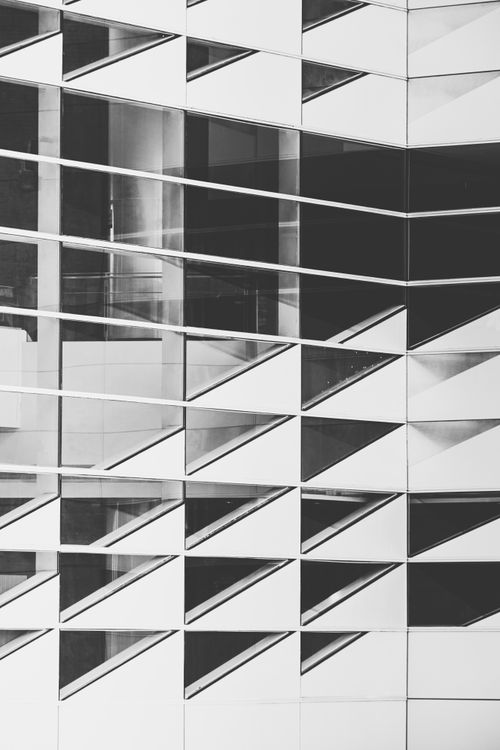 Free Geometric patterns on a modern building facade showcasing abstract architecture in black and white. Stock Photo