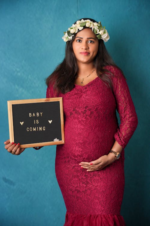 Pregnant Brunette Woman in Red Dress