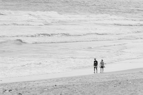 Couple Walking on Beach in Black and White