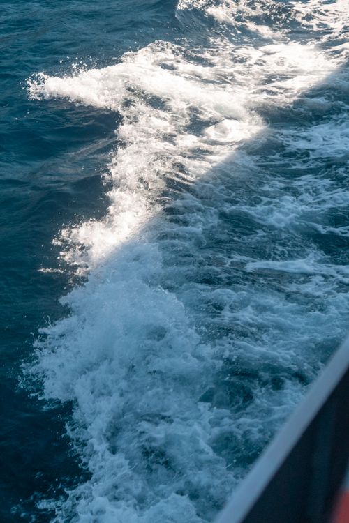 Free Vibrant ocean waves create a mesmerizing pattern as seen from a ship, showcasing the beauty of the sea. Stock Photo