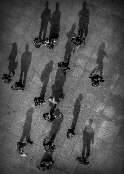 People and Their Shadows on Pavement