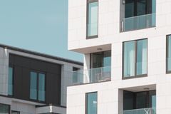 Contemporary apartment buildings in Berlin with elegant white facades and glass balconies.