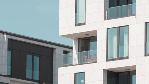 Contemporary apartment buildings in Berlin with elegant white facades and glass balconies.