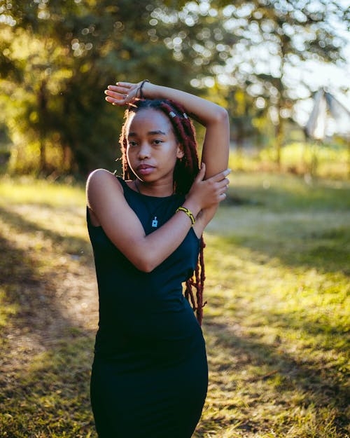 Young Woman in a Dress Posing in the Park 