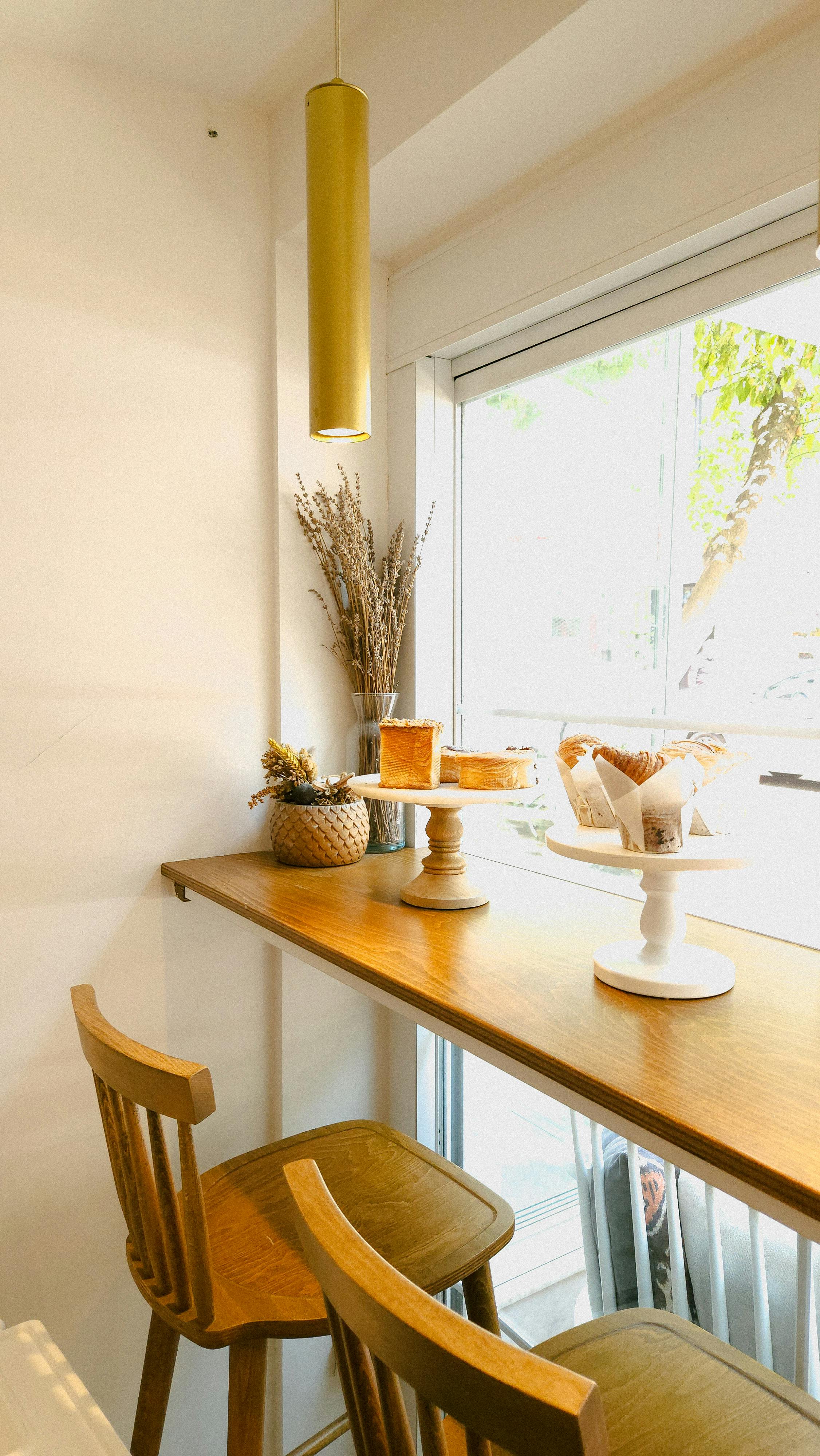 Trays with Cakes on Cafe Table by Window