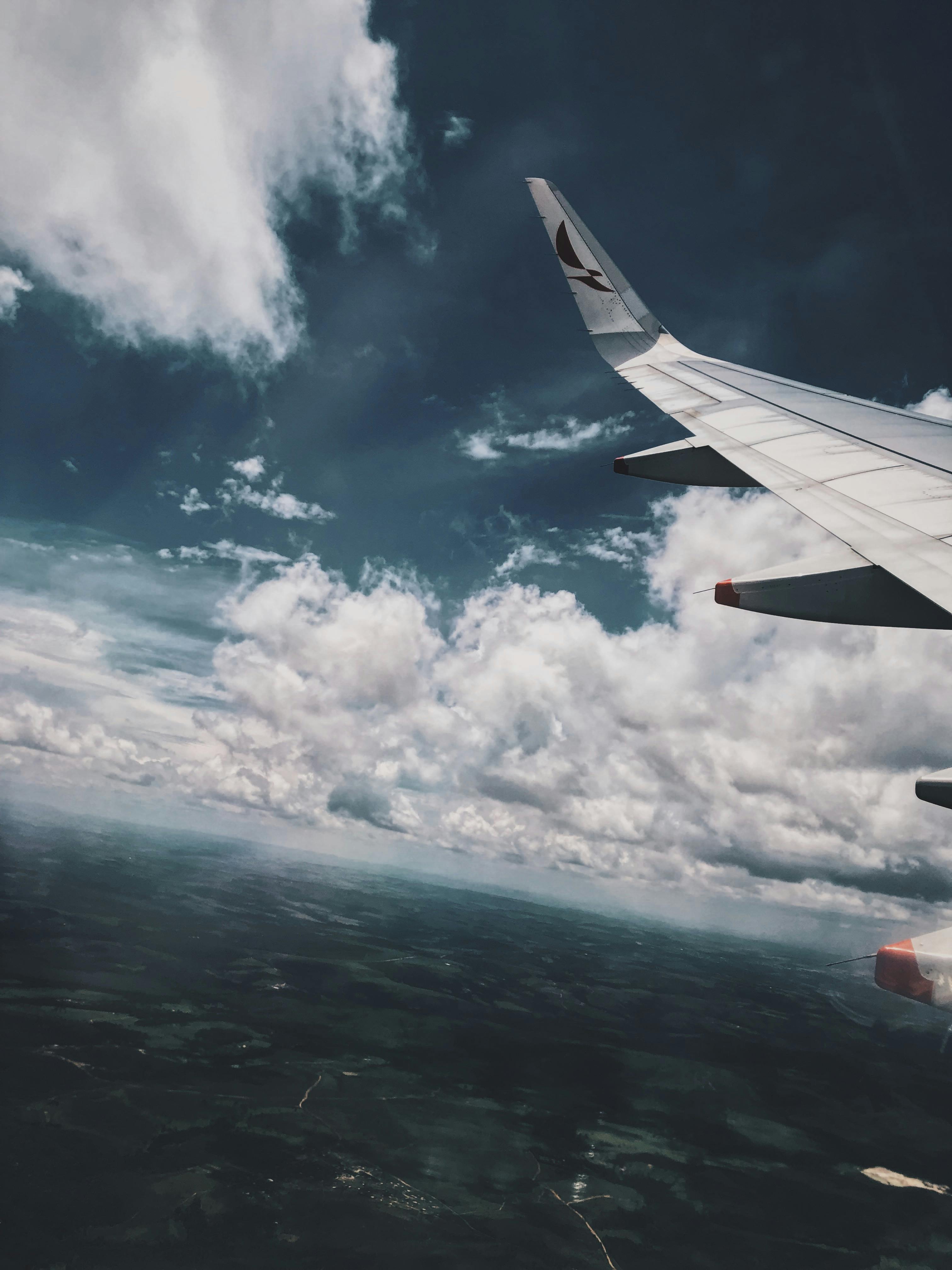 White Airliner Wing on Top of Sea Clouds · Free Stock Photo