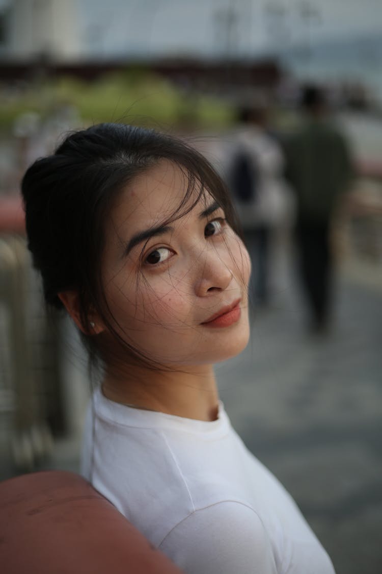 Portrait Of A Young Woman Sitting Outside 