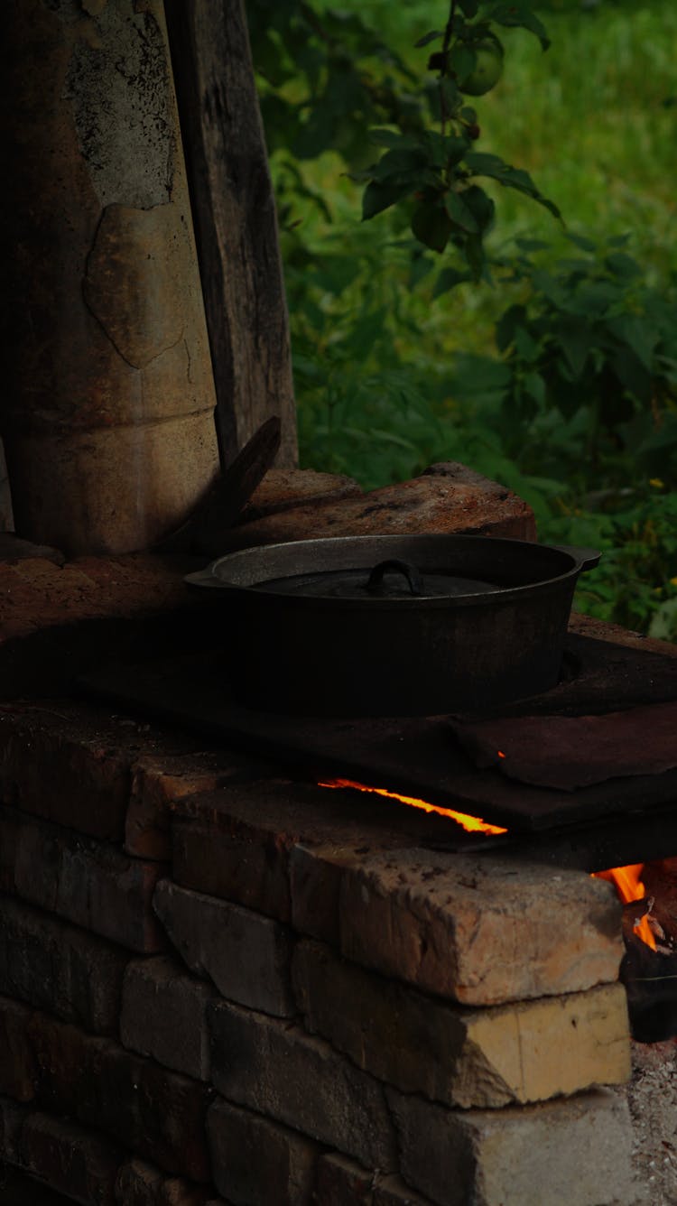 A Pot On A Stone Stove Outside 