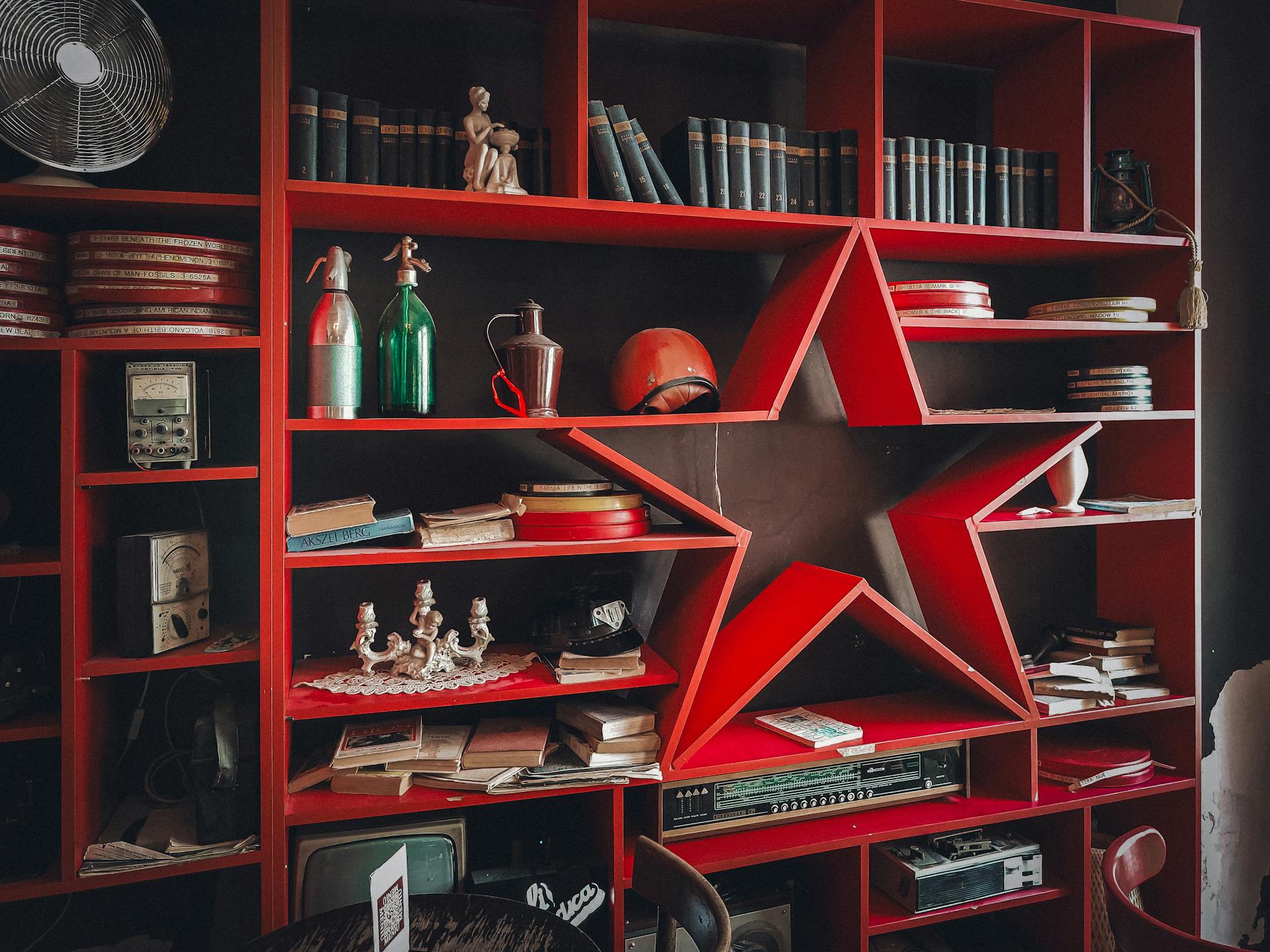 Red shelves with a star on them and a vase