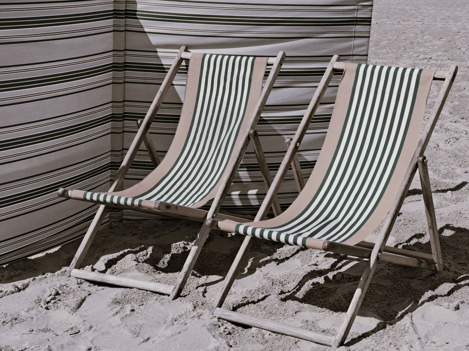 Two Deckchairs on a Beach