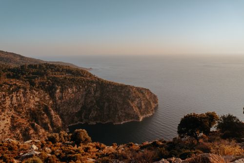 Free Gorgeous coastal scenery with rocky cliffs and tranquil sea at sunset. Perfect nature and travel stock image. Stock Photo