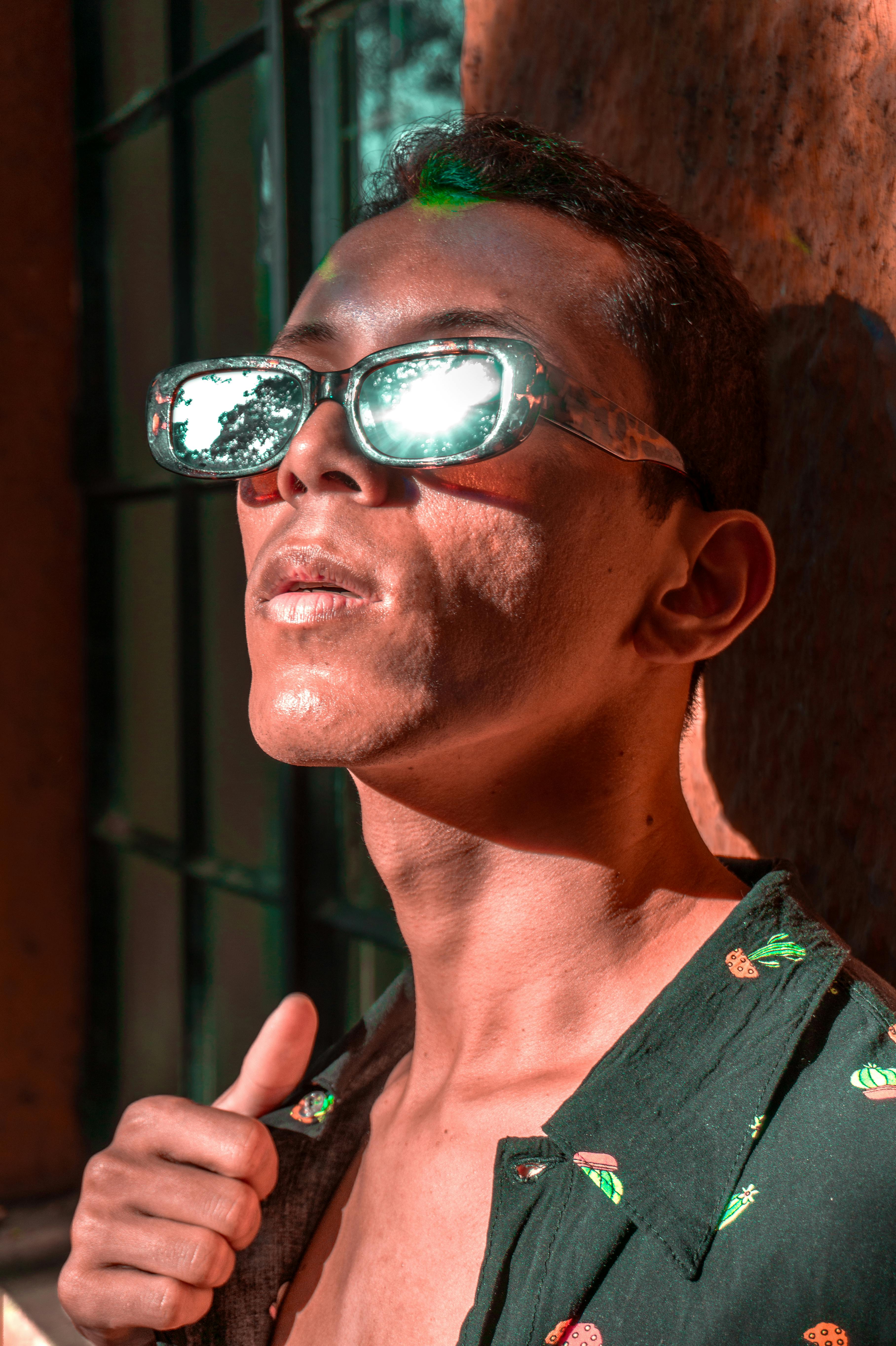 Man with Sunglasses Looking at Sun Free Stock Photo