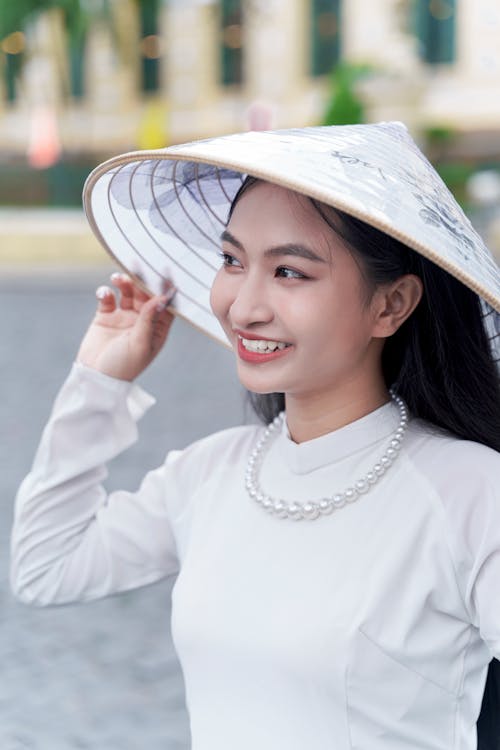 Portrait of Smiling Woman in Conical Hat