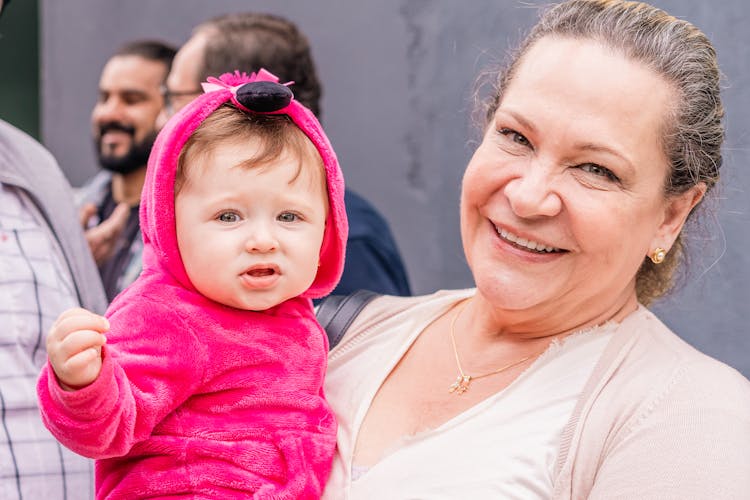 Smiling Mother Holding Daughter