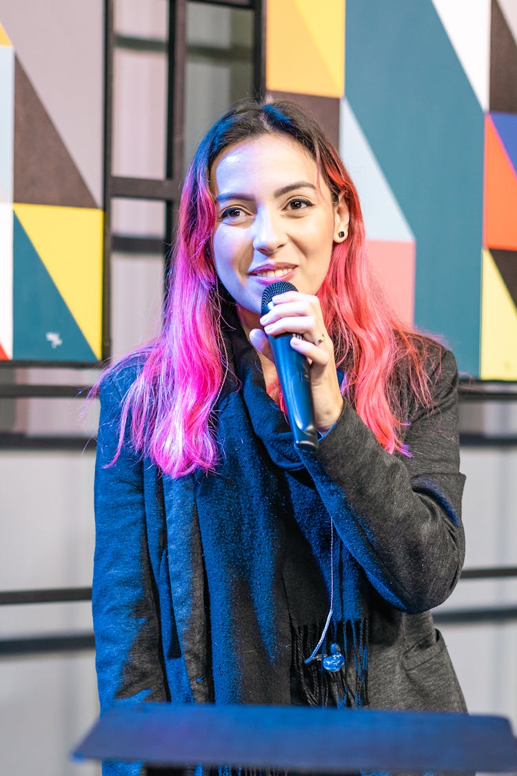 Smiling Woman Speaking With Microphone