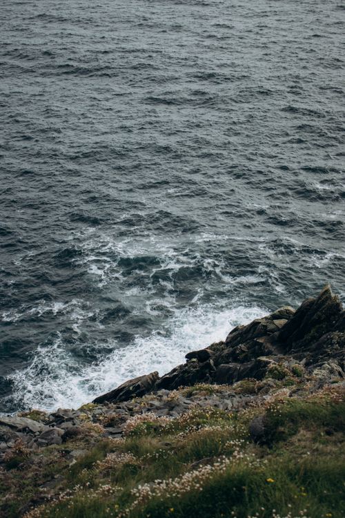 Free Waves crashing on a rocky cliffside with dramatic ocean views, emphasizing natural beauty. Stock Photo