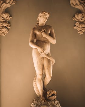 Elegant marble statue of a woman with a serpent in Stresa, Italy exhibit.