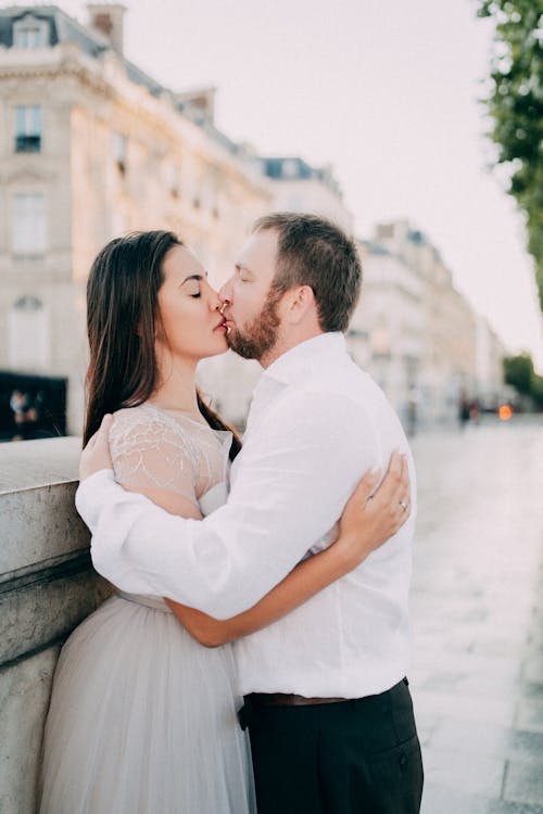 Newlyweds Kissing in a City
