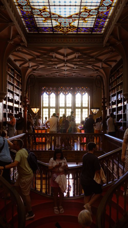 Free Explore the enchanting interior of Lello Bookstore in Porto, featuring a stunning stained glass ceiling and a vibrant atmosphere. Stock Photo