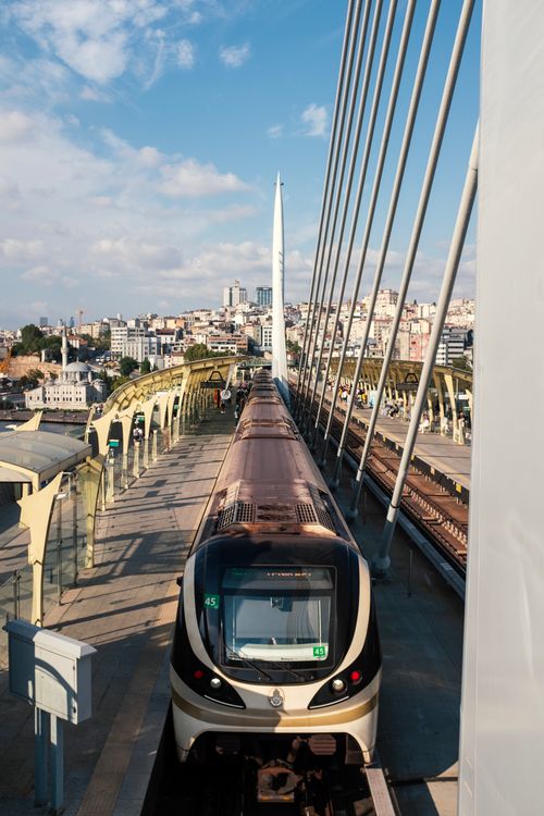 Free An urban train travels across the distinctive Haliç Bridge in Istanbul, showcasing the city's vibrant architecture and transportation. Stock Photo