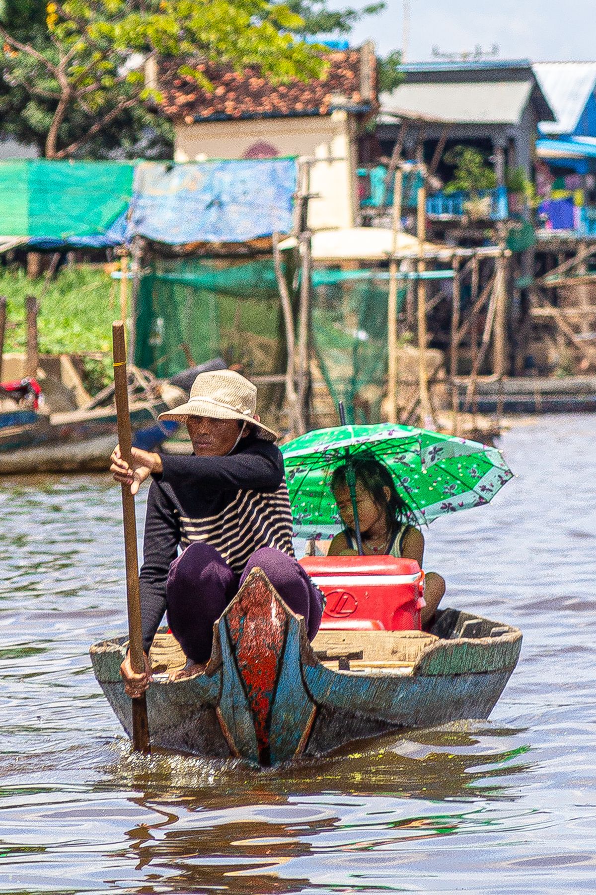 Mother and daughter on the water, Tonle Sap, Cambodia
