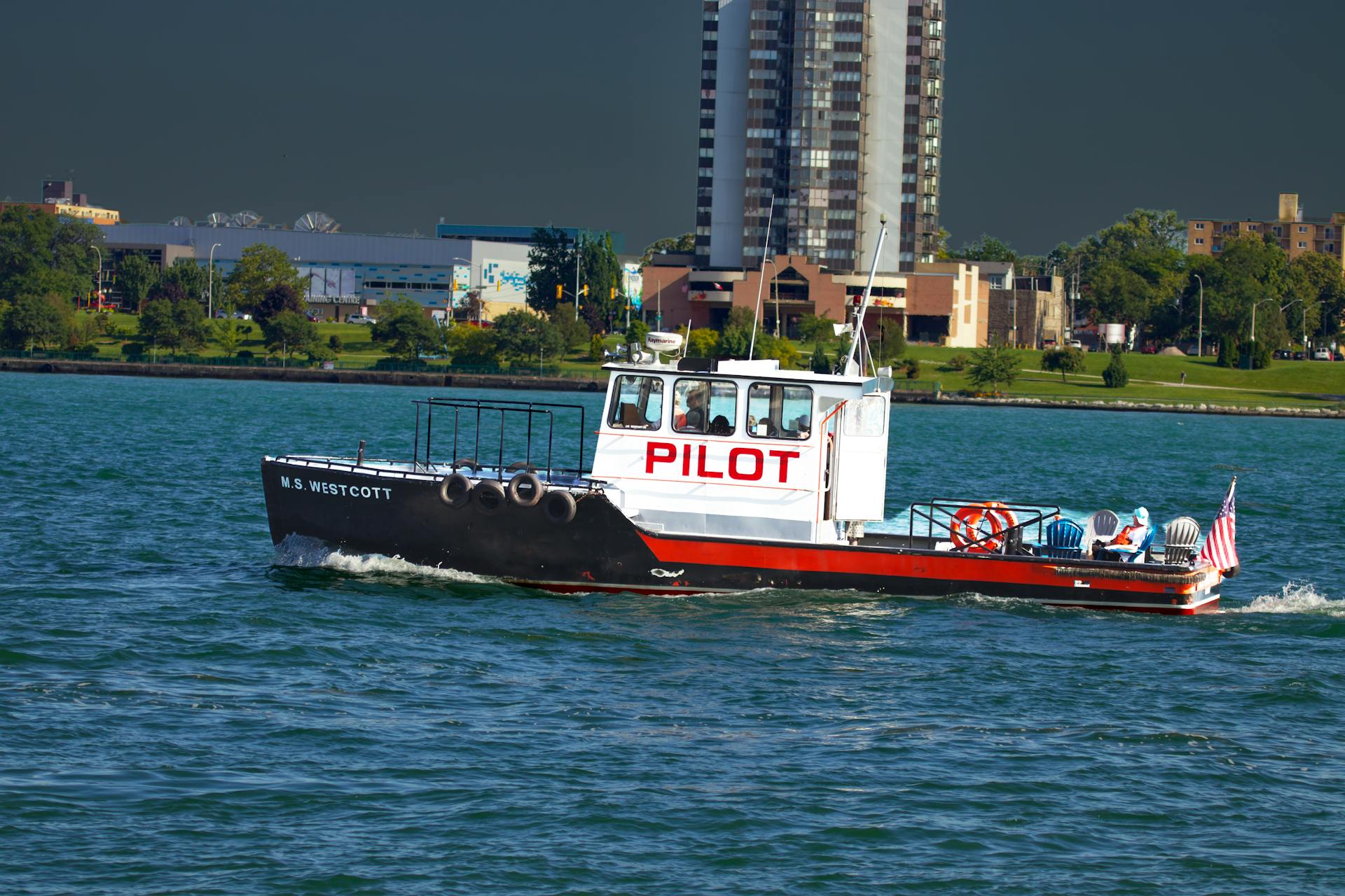 The MS Westcott pilot boat navigates the Detroit River with a city backdrop.