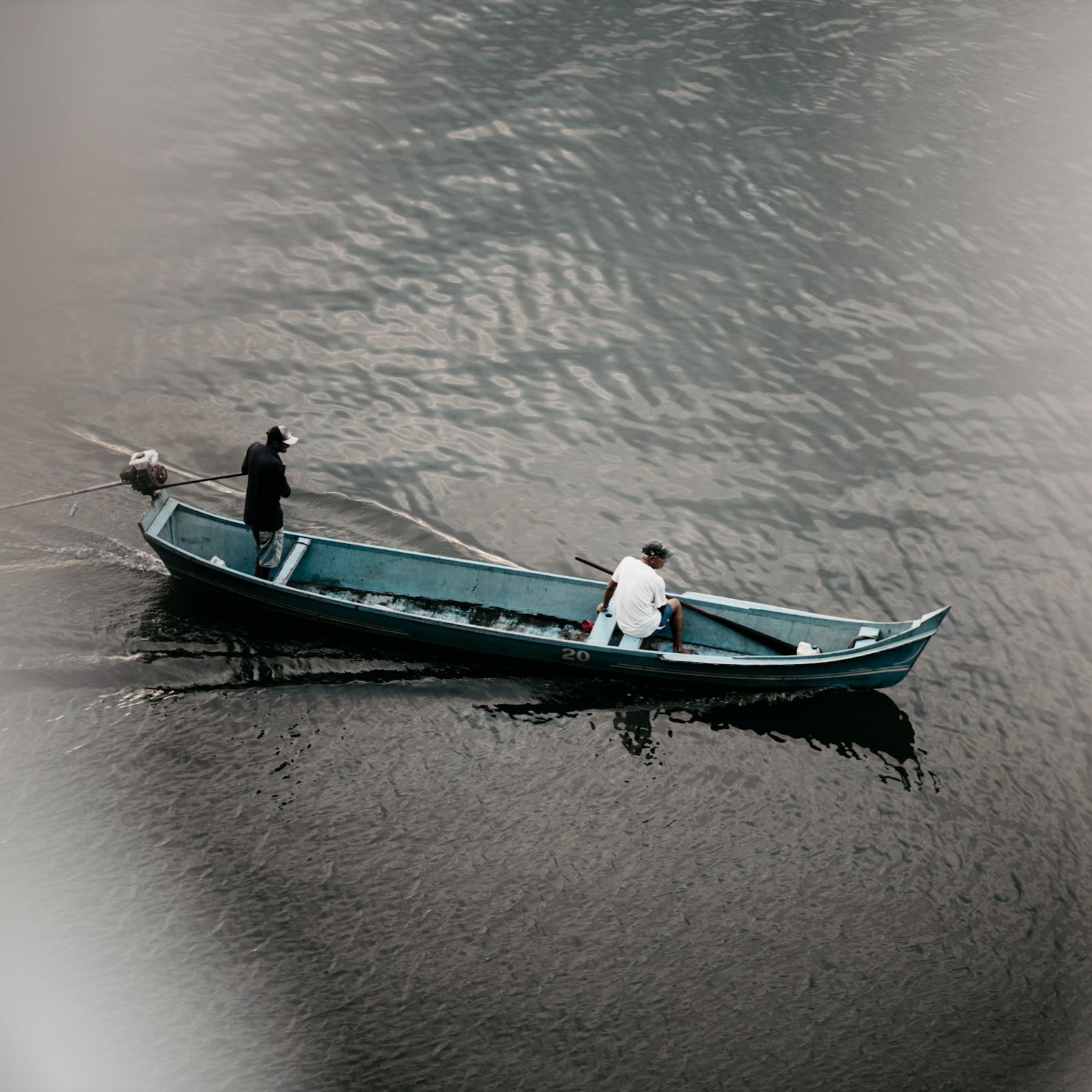 Man Rowing Boat Phot A Man Rowing A Small Boat With a Sail · Free Stock Photo