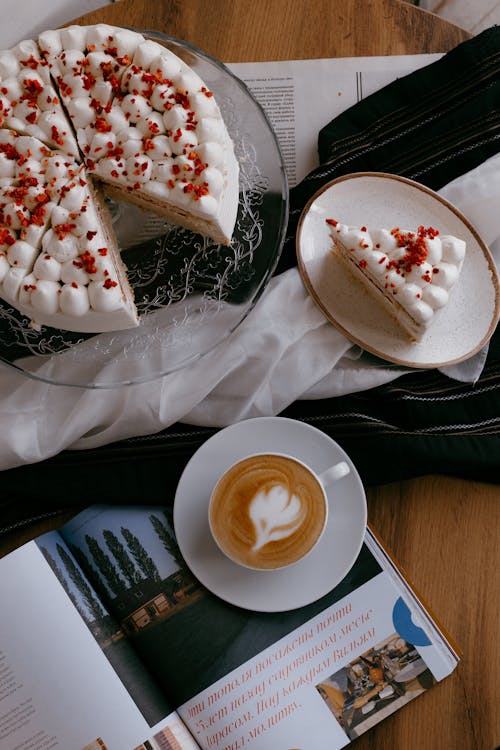 Cup of Coffee and Sliced Sponge Cake Sprinkled with Cranberries on a Table