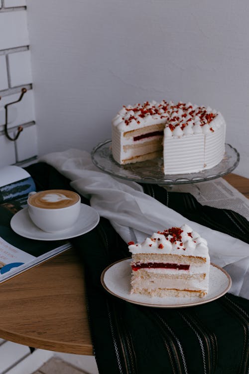 Cake on Tray Set next to Cup of Coffee