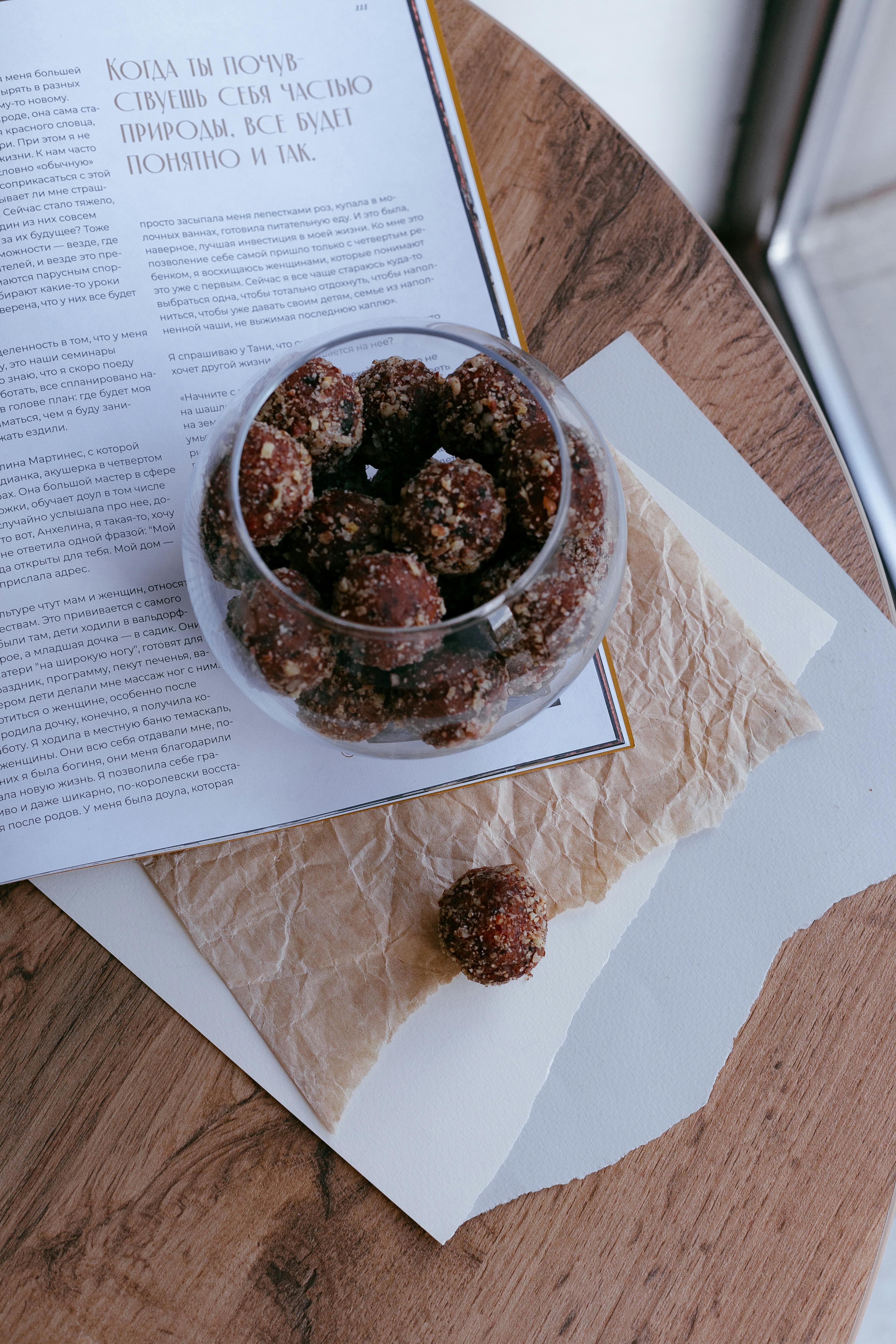 homemade truffles in chocolate icing with nuts on a table