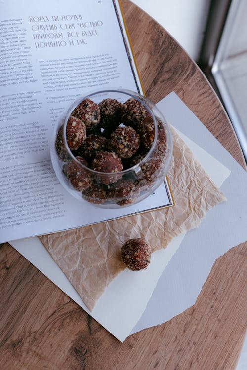 Homemade Truffles in Chocolate Icing with Nuts on a Table