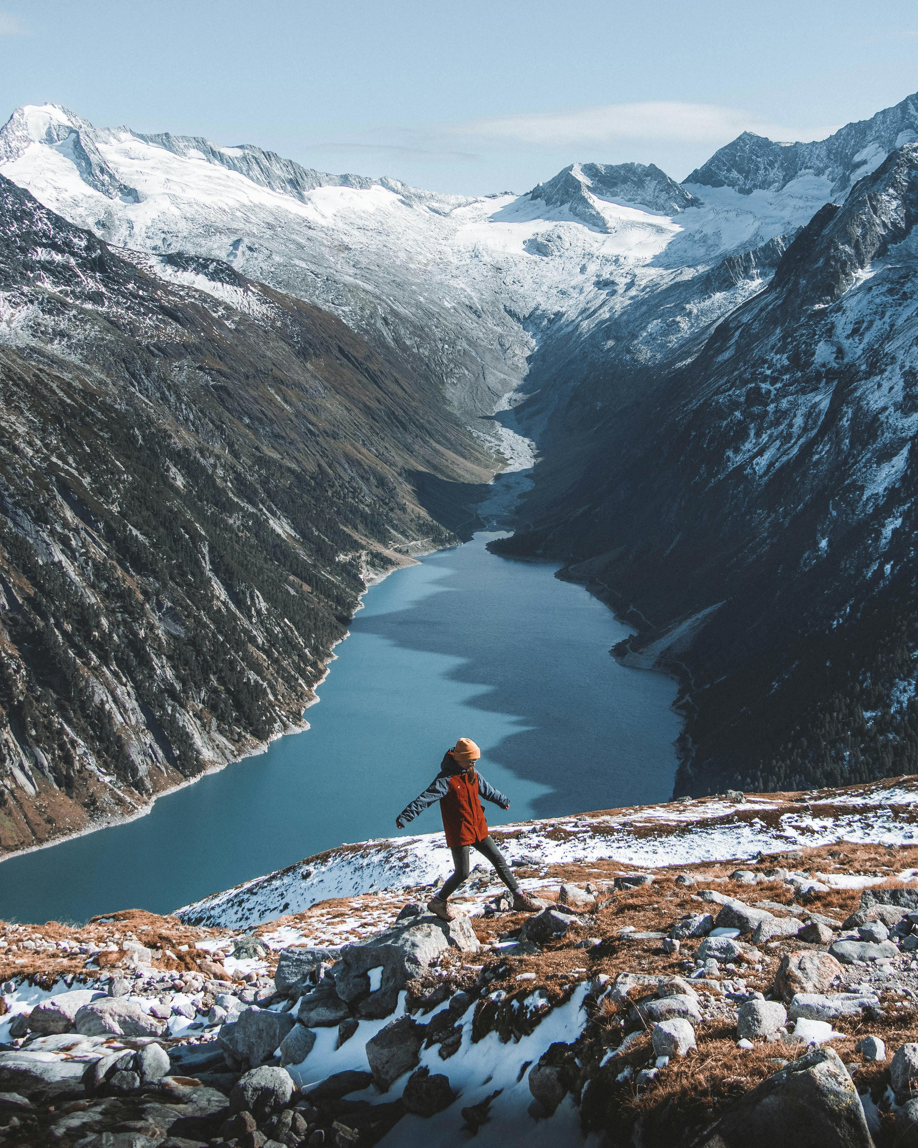 Explore the majestic snowy Alps with a lone hiker, capturing the spirit of adventure and natural beauty.