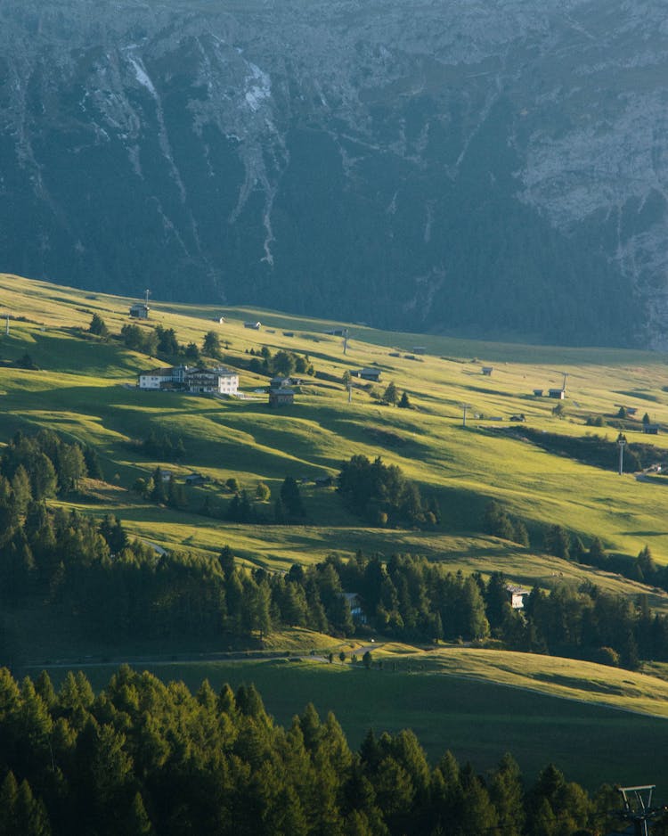 Buildings Scattered On Green Hillside In Moun