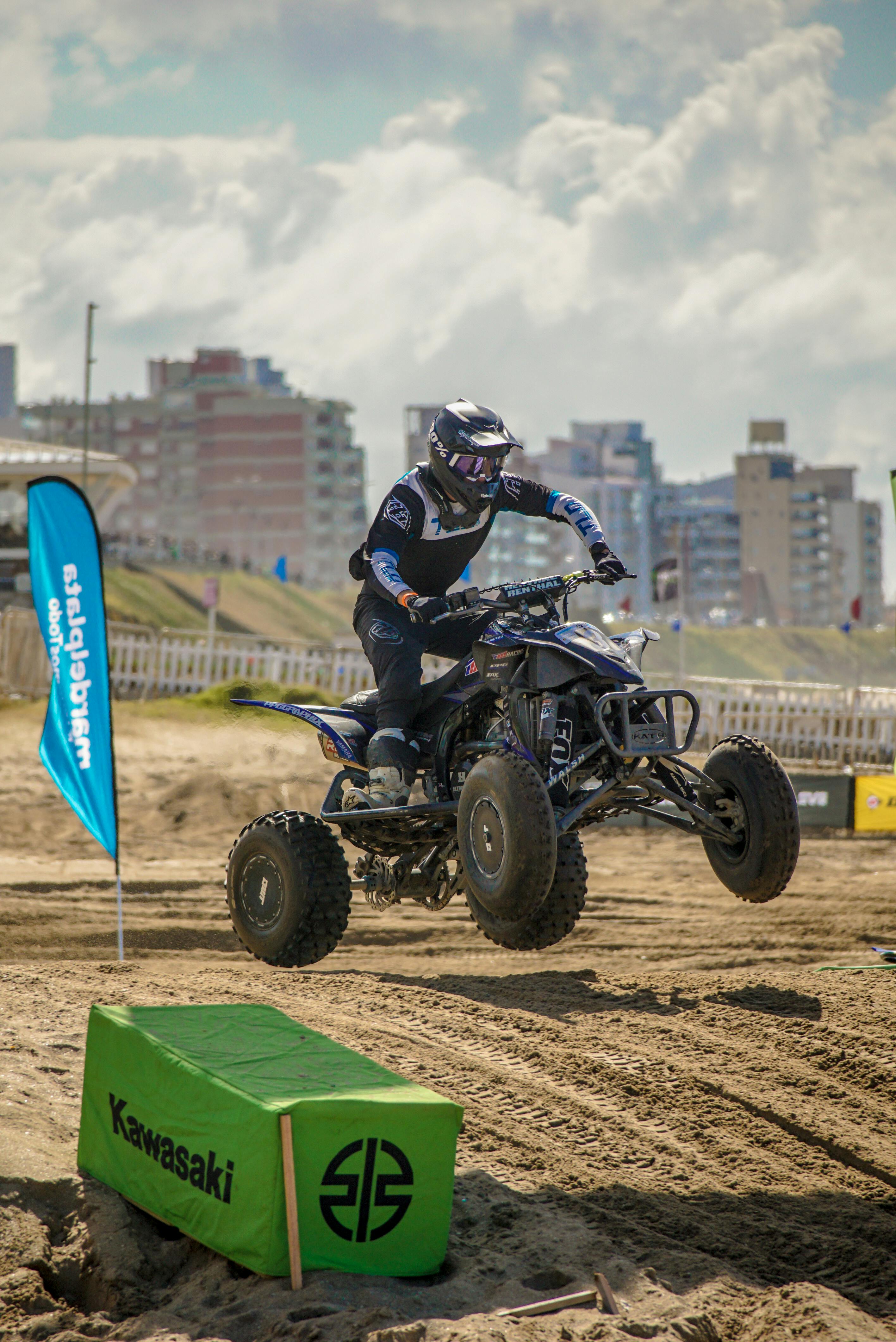 Person Wearing Helmet Jumping on Quad Bike · Free Stock Photo