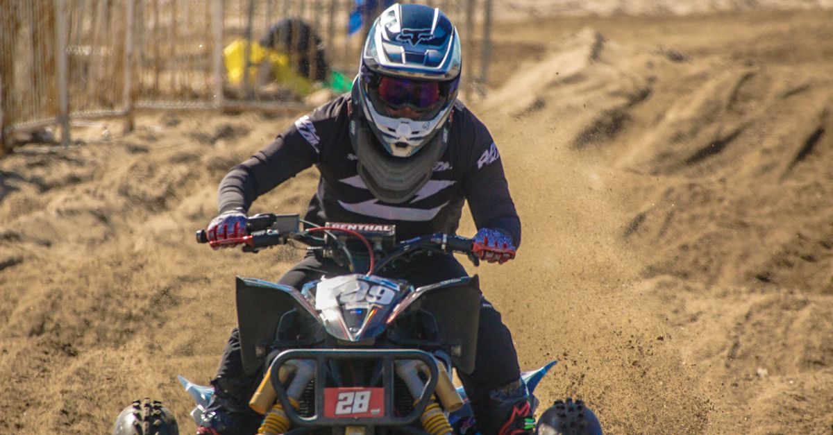 A Person Riding on a Quad Bike on the Beach at a Championship · Free ...