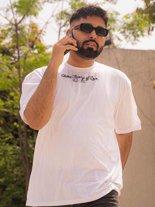 Bearded Man in White T-Shirt Talking on Phone