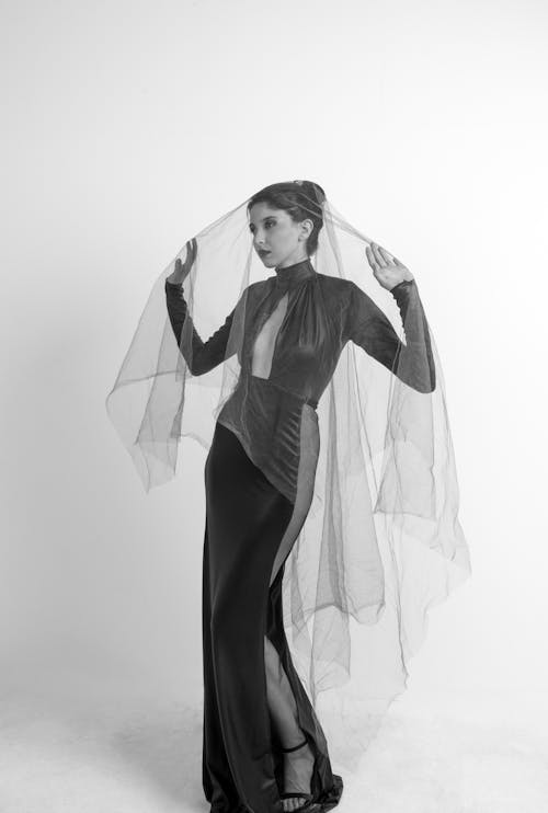 Woman in Elegant Black Dress and Veil