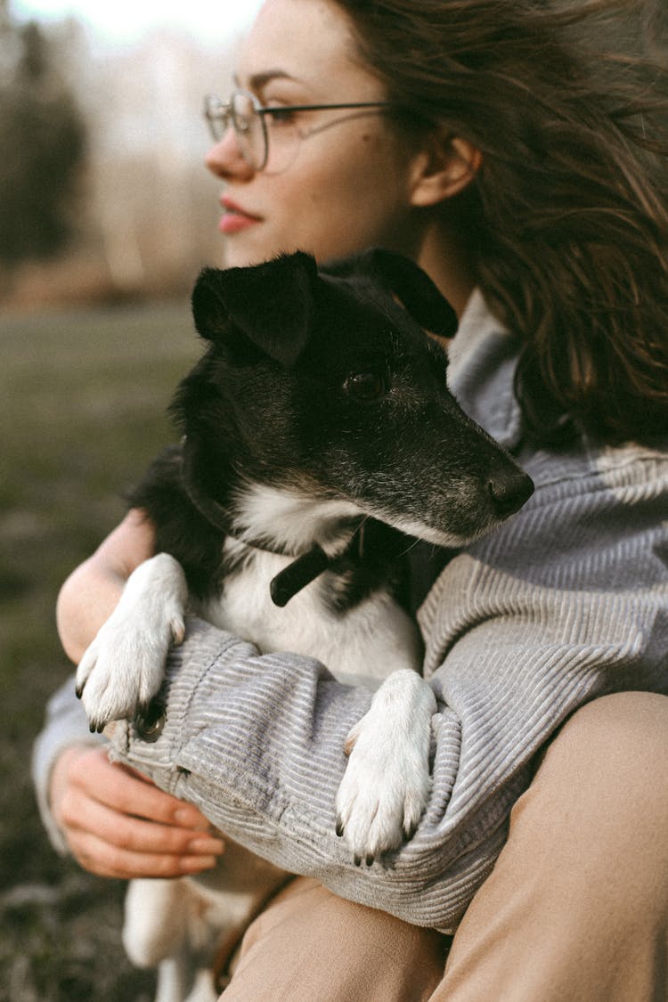 Woman Holding Dog In Arms