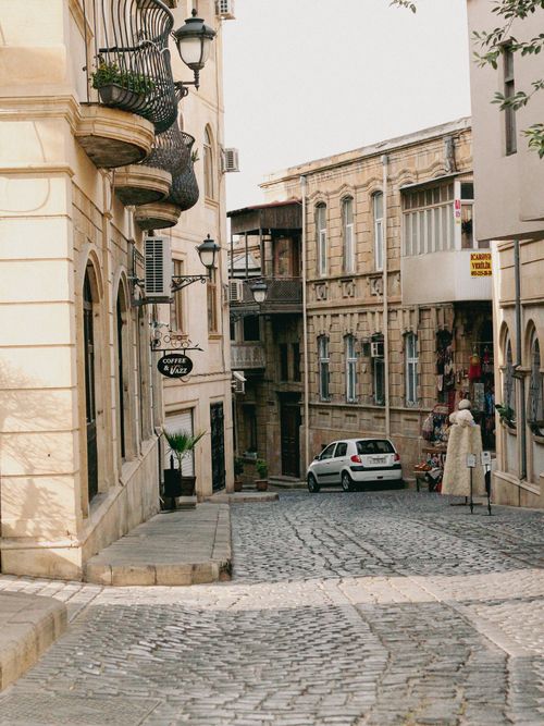 Free Explore a quaint cobblestone street surrounded by classic architecture in a historic town, exuding old-world charm. Stock Photo