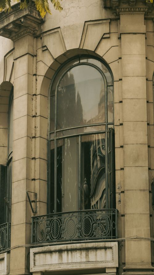 Free Elegant arched window on a historic facade in Buenos Aires, reflecting urban architecture. Stock Photo